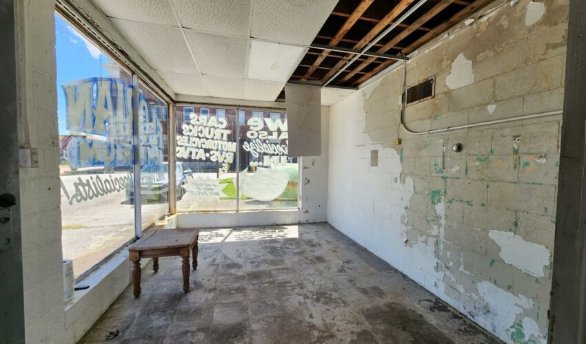 Interior of service station on Oxford's towns square before rehabilitation.